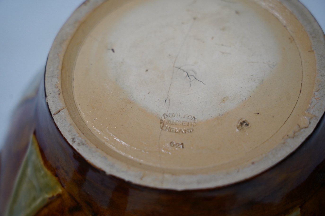 A Doulton Lambeth jardiniere, a small bowl and a pair of siliconware candlesticks, largest 18cm high. Condition - poor